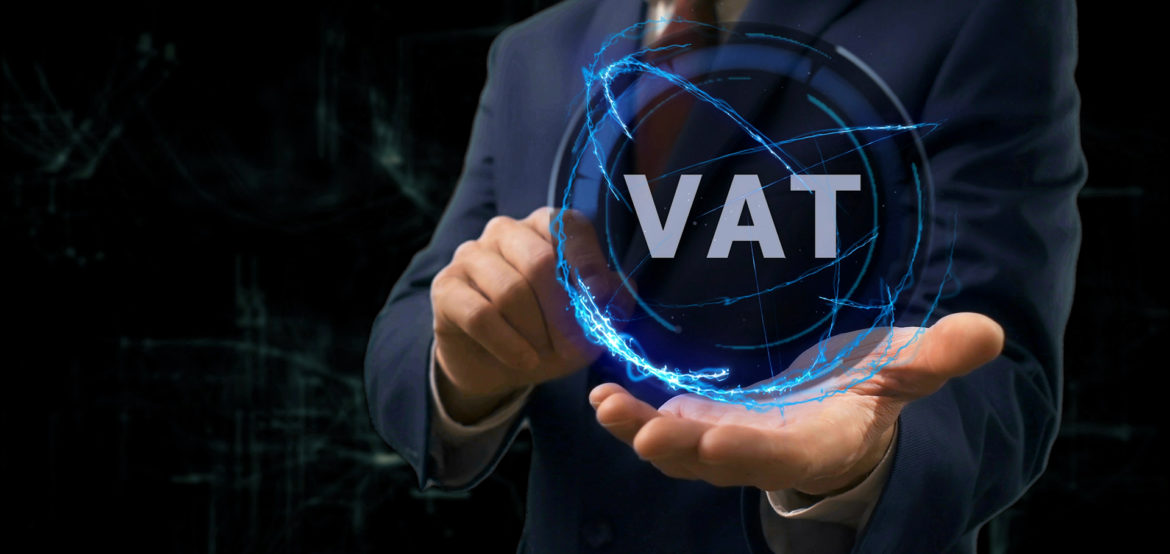 Businessman shows concept hologram VAT on his hand. Man in business suit with future technology screen and modern cosmic background